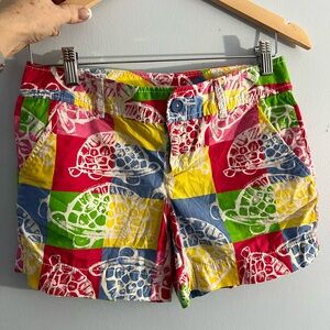 Lilly Pulitzer Turtle time shorts on a patch work background w